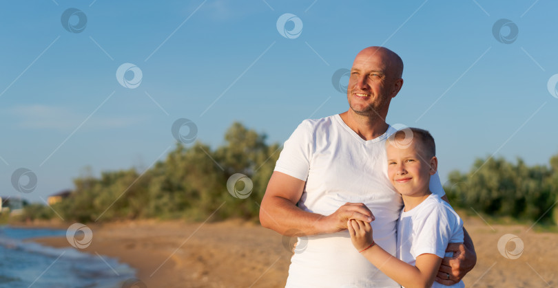 Скачать Мужчина и мальчик стоят на пляже фотосток Ozero