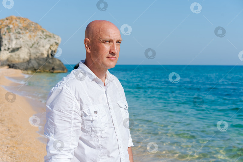 Скачать Мужчина стоит на пляже спиной к камере фотосток Ozero