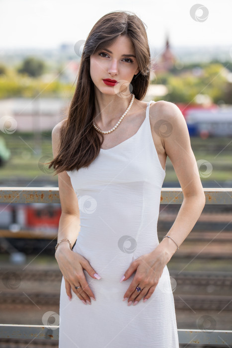 Скачать Портрет молодой красивой брюнетки в белом платье фотосток Ozero
