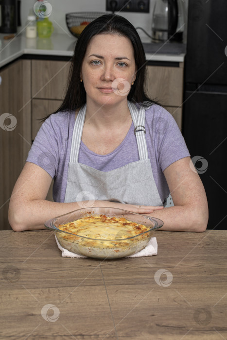 Скачать Портрет брюнетки средних лет на кухне в фартуке фотосток Ozero