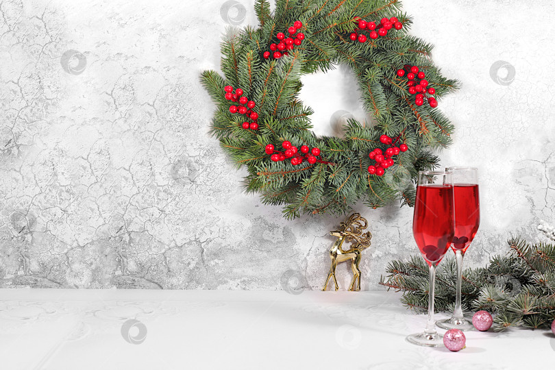 Скачать Рождественский алкогольный коктейль с красным шампанским "Мимоза" и клюквой в бокалах на праздничном фоне с еловыми ветками и украшениями, концепция бара и сочельника, алкогольные напитки на вечеринке фотосток Ozero