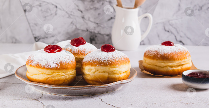 Скачать Сладкие пончики в сахарной пудре с джемом на тарелке на столе веб-баннер фотосток Ozero
