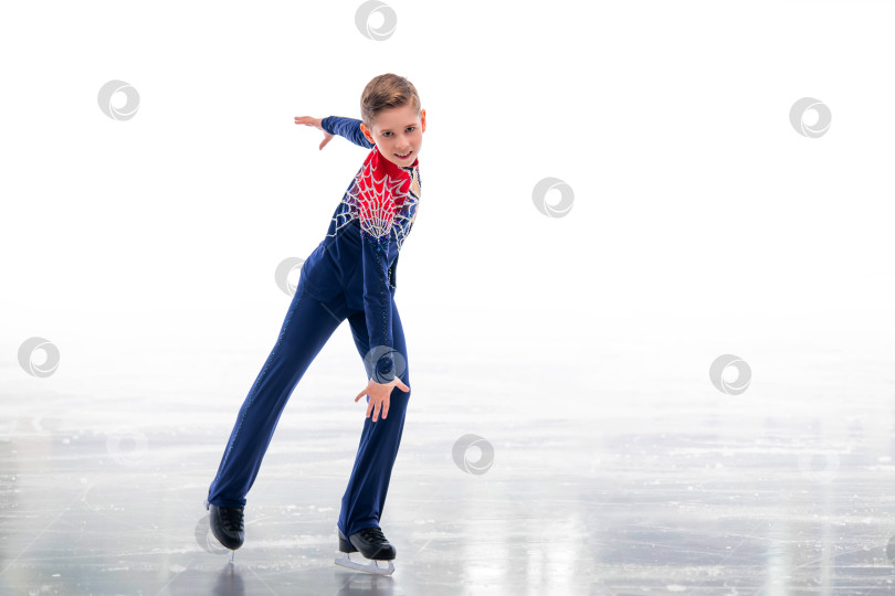 Скачать Мальчик-фигурист в шапке Санта-Клауса катается на коньках. фотосток Ozero