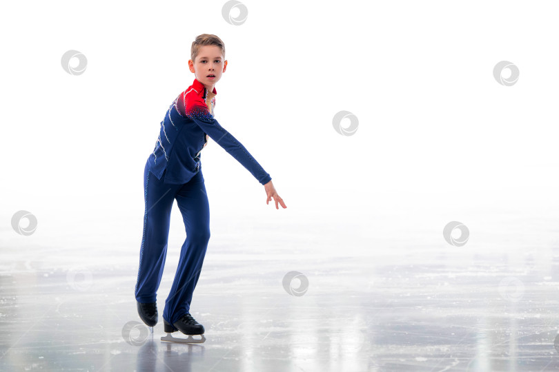 Скачать Мальчик-фигурист в шапке Санта-Клауса катается на коньках. фотосток Ozero