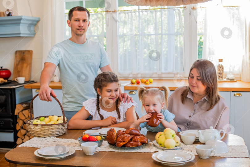 Скачать Семья наслаждается совместным завтраком на уютной кухне фотосток Ozero
