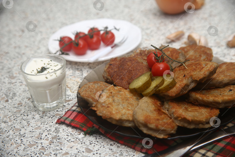 Скачать Блюдо жареные драники с овощами и приборами фотосток Ozero