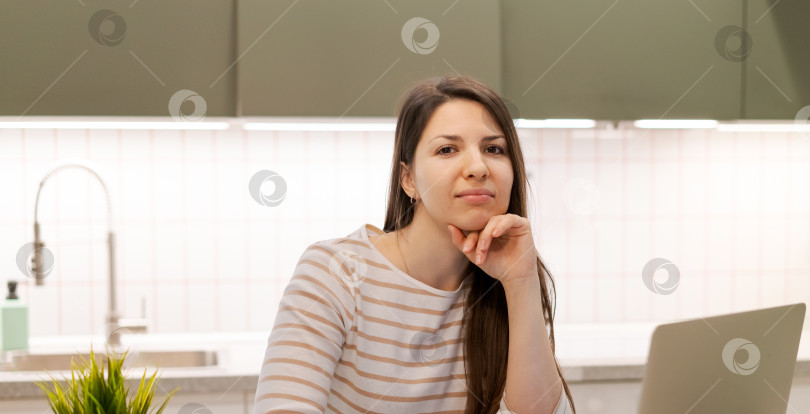 Скачать За столом сидит женщина, перед ней ноутбук фотосток Ozero