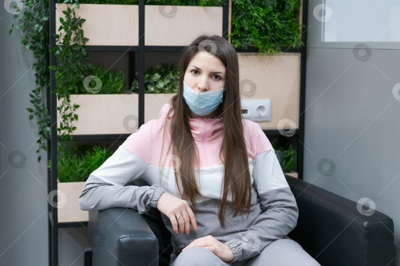 Скачать Женщина в маске сидит на стуле фотосток Ozero