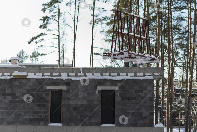 Скачать Кран поднимает пластиковые окна на строительной площадке фотосток Ozero