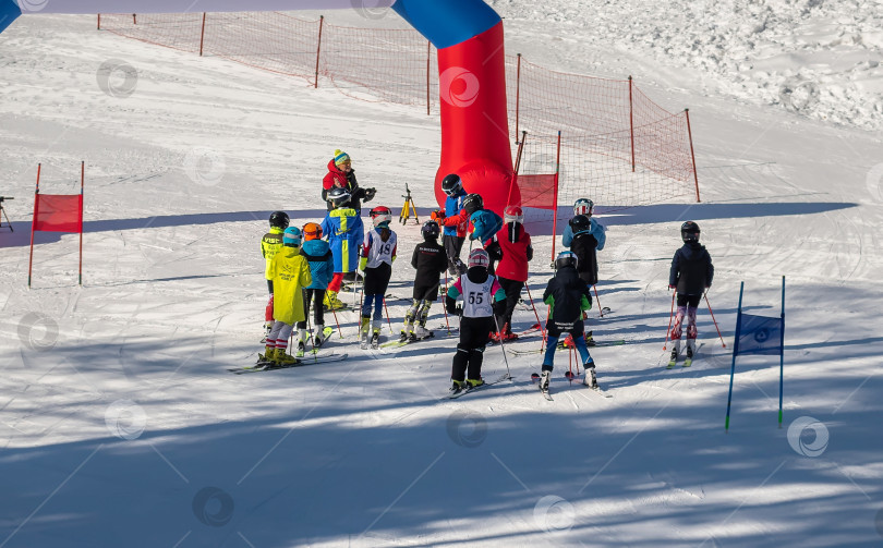 Скачать Россия, Красноярск 25 февраля 2025г. Спортивный тренер и инструктор по лыжному спорту работает со своими учениками на заснеженном горнолыжном склоне. фотосток Ozero