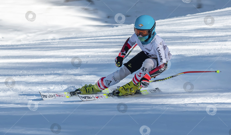 Скачать Россия, Красноярск 25 февраля 2025г. Мальчик лыжник, спускается на лыжах по снежному склону. фотосток Ozero