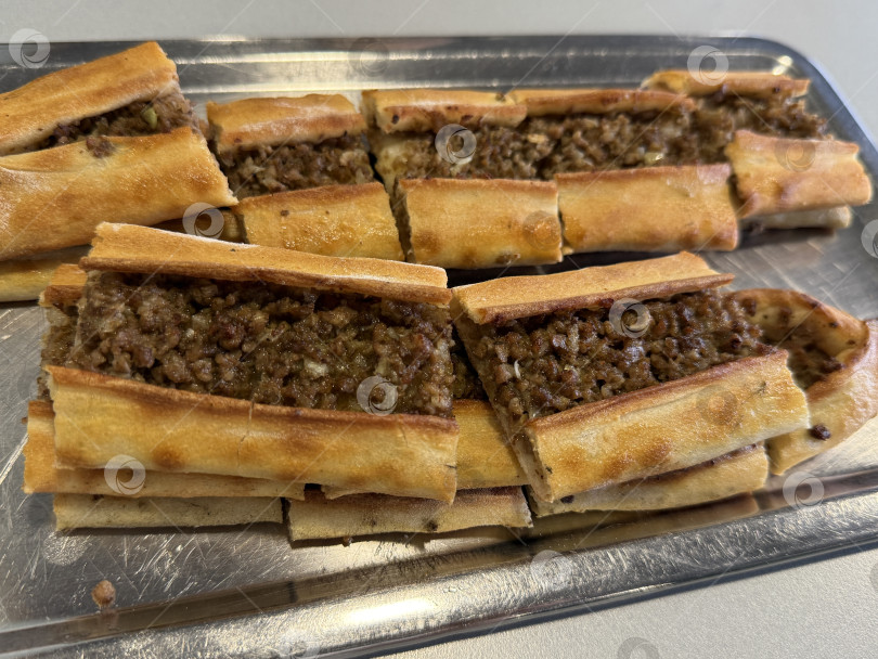 Скачать Пиде по-турецки с мясным фаршем на металлическом подносе, традиционное блюдо для запекания, вид сверху фотосток Ozero