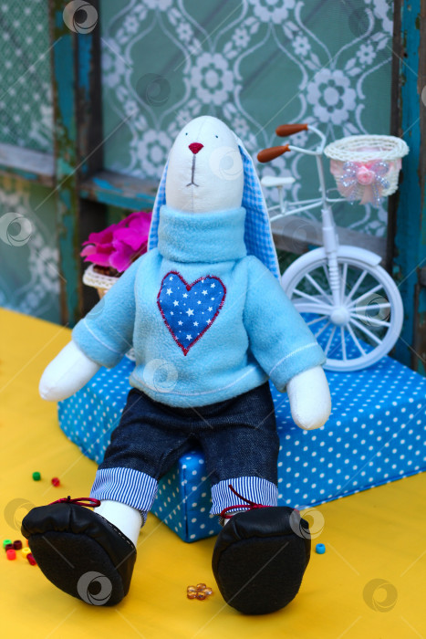 Скачать Плюшевый кролик ручной работы: Уютный пасхальный декор и креативная идея подарка с игривыми цветочными акцентами фотосток Ozero