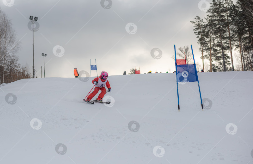 Скачать Россия, Красноярск 25 февраля 2025г. Мальчик лыжник, спускается на лыжах по снежному склону. фотосток Ozero