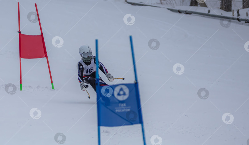 Скачать Россия, Красноярск 25 февраля 2025г. Мальчик лыжник, спускается на лыжах по снежному склону. фотосток Ozero