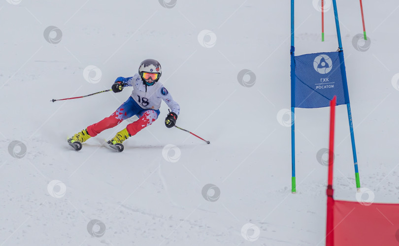 Скачать Россия, Красноярск 25 февраля 2025г. Мальчик лыжник, спускается на лыжах по снежному склону. фотосток Ozero