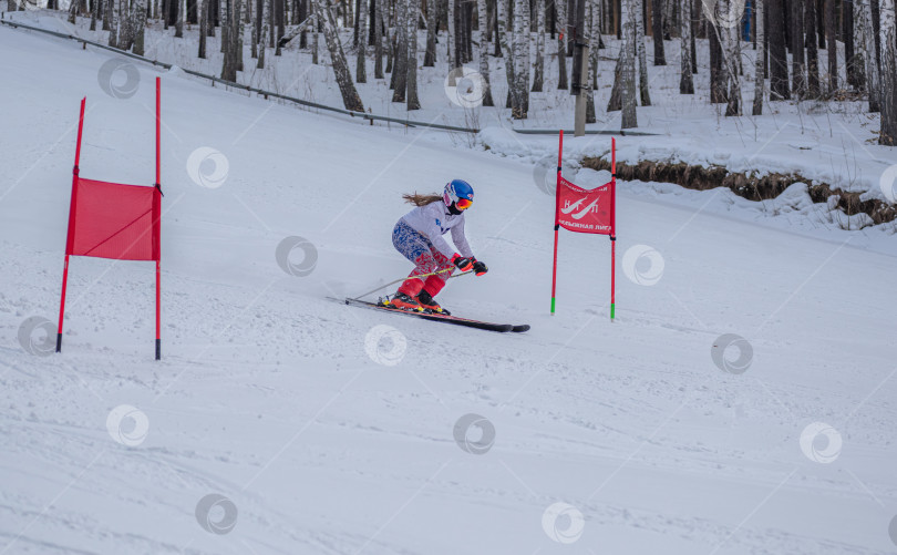 Скачать Россия, Красноярск 25 февраля 2025г. Девочка лыжница, спускается на лыжах по снежному склону. фотосток Ozero