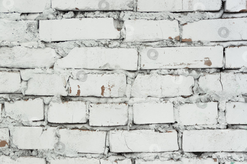 Скачать Неровная текстура кирпичной стены, окрашенной в белый цвет фотосток Ozero