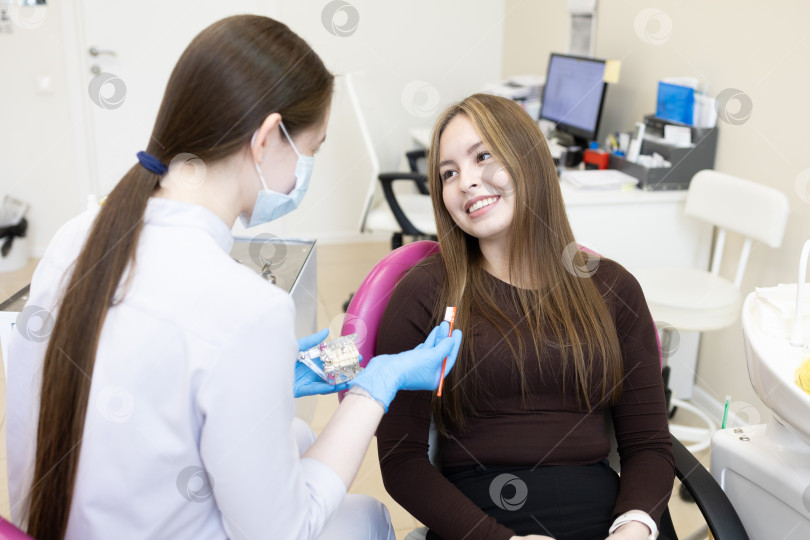 Скачать Стоматолог показывает женщине, как чистить зубы фотосток Ozero