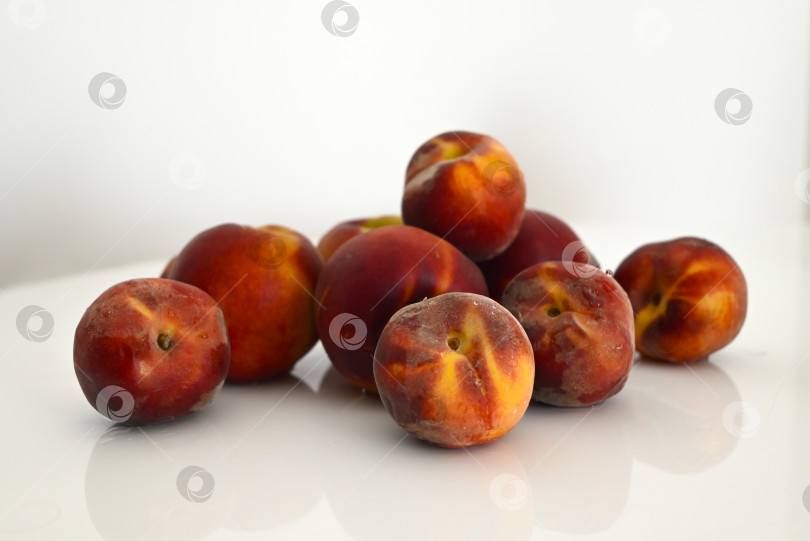 Скачать Спелые сочные персики на белом столе при мягком освещении фотосток Ozero