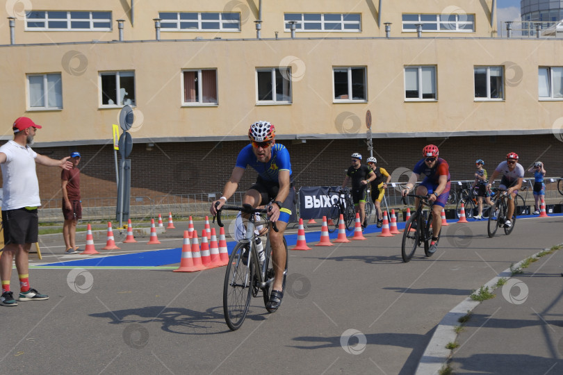 Скачать Триатлон. Соревнования.  Велосипедная дистанция. Первые атлеты на велосипедной дорожке. фотосток Ozero