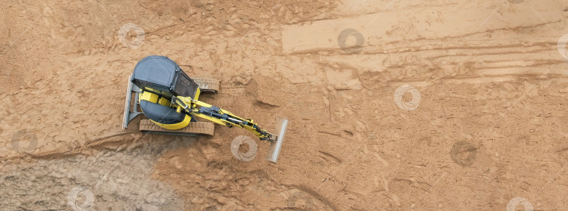 Скачать Небольшой универсальный трактор работает на строительной площадке фотосток Ozero