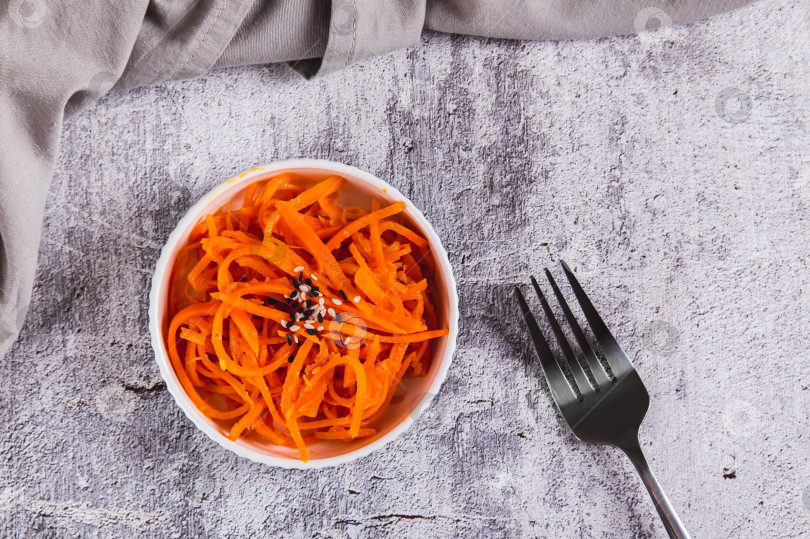 Скачать Салат из маринованной корейской моркови на тарелке на столе вид сверху фотосток Ozero