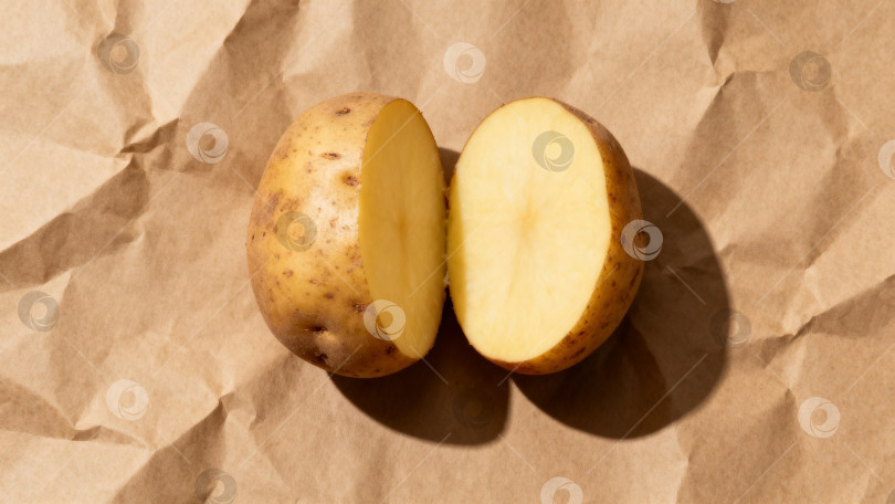 Скачать Разрезанный вдоль картофель на крафт-бумаге фотосток Ozero