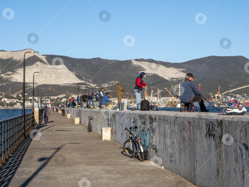 Скачать 22 августа 2025 года рыбаки сидят и ловят рыбу на пирсе в Новороссийске, Россия, на побережье Черного моря. Отдых на набережной фотосток Ozero