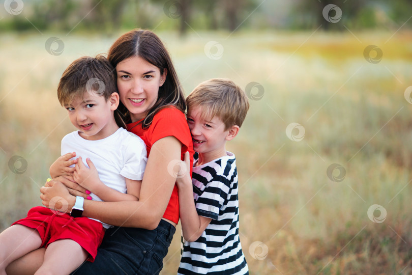 Скачать Любящая мама с двумя сыновьями на открытом воздухе фотосток Ozero