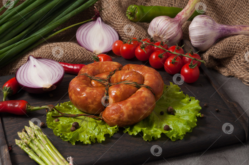 Скачать колбаса, приготовленная в дровяной печи, украшенная свежими овощами фотосток Ozero