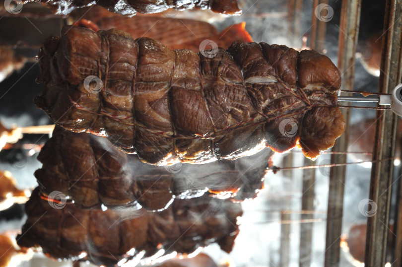 Скачать копчение мясных продуктов на производстве. ароматный дым фотосток Ozero