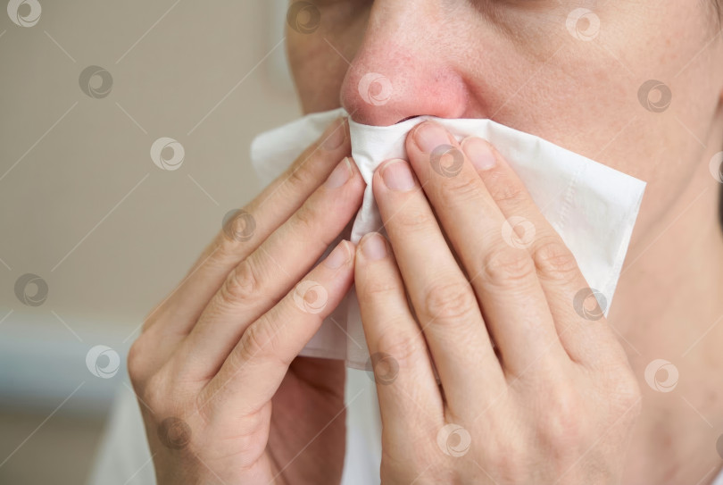 Скачать Человек, чихающий с помощью салфетки, вызывает аллергию или простуду с насморком. Создан искусственный интеллект. фотосток Ozero