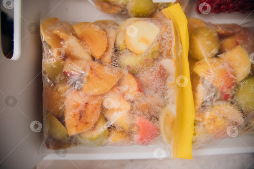 Скачать Фрукты и ягоды упаковывают в полиэтиленовые пакеты и хранят в морозильной камере. Свежие и полезные продукты в любое время года. фотосток Ozero