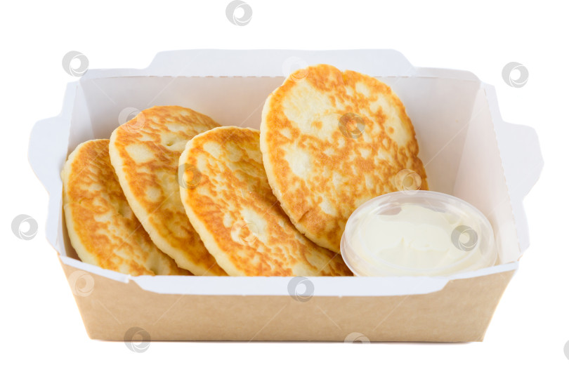 Скачать Сладкий толстый блинчик со сметанным кремом в крафтовой бумажной коробке на вынос на белом фоне вид сбоку крупным планом с возможностью копирования вкусный пикантный завтрак фотосток Ozero