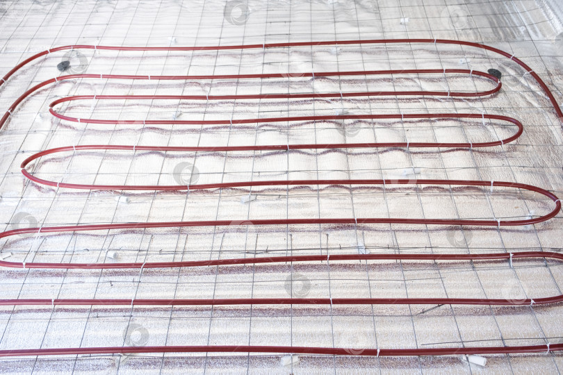 Скачать Монтаж системы теплого пола, укладка труб отопления на утепление, монтаж теплого пола, строительные и ремонтные работы, энергоэффективность. фотосток Ozero