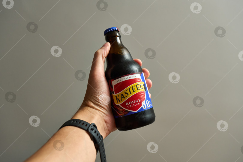 Скачать Тюмень, Россия - 3 декабря 2025 года: логотип Kasteel на крышке пивной бутылки на деревянном фоне, создающий непринужденную атмосферу фотосток Ozero