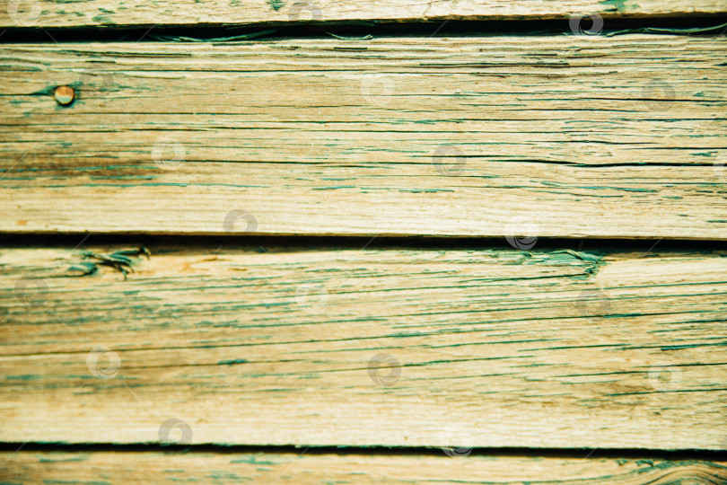 Скачать Фон выполнен из дерева с текстурой и зеленой краской. Рисунок поверхности деревянного стола из деревянных досок, абстрактная текстура. фотосток Ozero