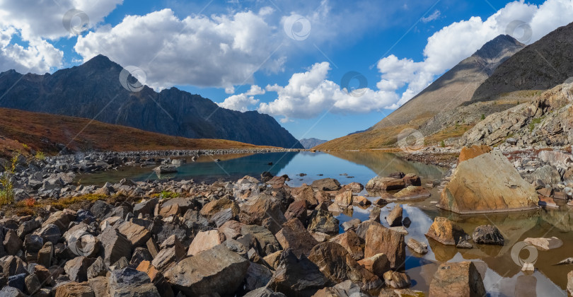 Скачать Величественные горы обрамляют спокойное мелководное озеро фотосток Ozero