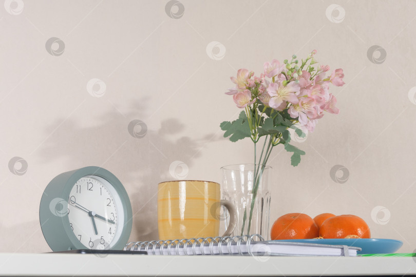 Скачать Уютное место для утренней работы с будильником, блокнотом, кофе и свежими фруктами. Низкий угол обзора. фотосток Ozero