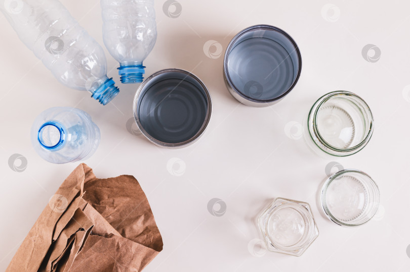 Скачать Крупный план бумаги, стекла, металла и пластика для раздельного сбора отходов на столе, вид сверху фотосток Ozero