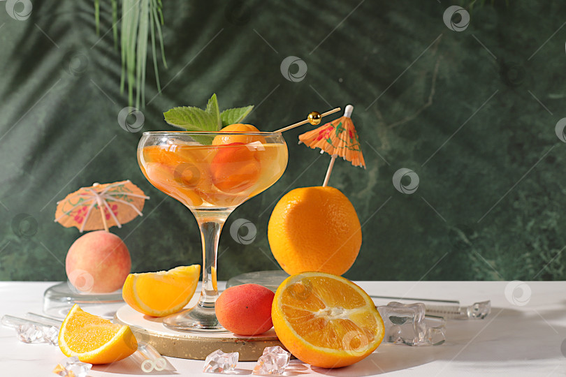Скачать Алкогольный коктейль или пунш, ягоды персика, абрикоса и мяты на элегантном фоне, минималистичная концепция для бара и праздничной вечеринки, кафе, рекламный баннер, современный натюрморт с фруктами. фотосток Ozero