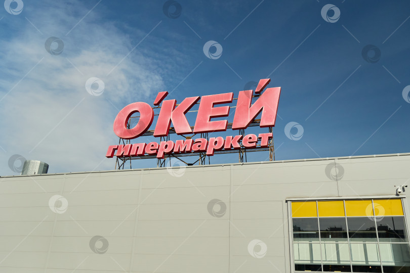 Скачать Тюмень, Россия - 6 сентября 2026 года: Вывеска гипермаркета "ОКЕЙ" на красной крыше фотосток Ozero