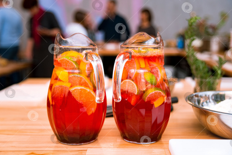 Скачать Безалкогольные напитки цитрусовые лимонады в больших стеклянных кувшинах на столе фотосток Ozero
