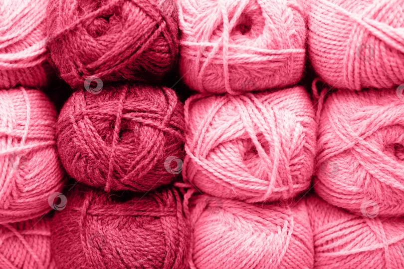Скачать фон из рядов мотков пушистой шерстяной пряжи для вязания мягких цветов красного, розового и фиолетового оттенков. окрашен в viva magenta, трендовый цвет 2023 года фотосток Ozero