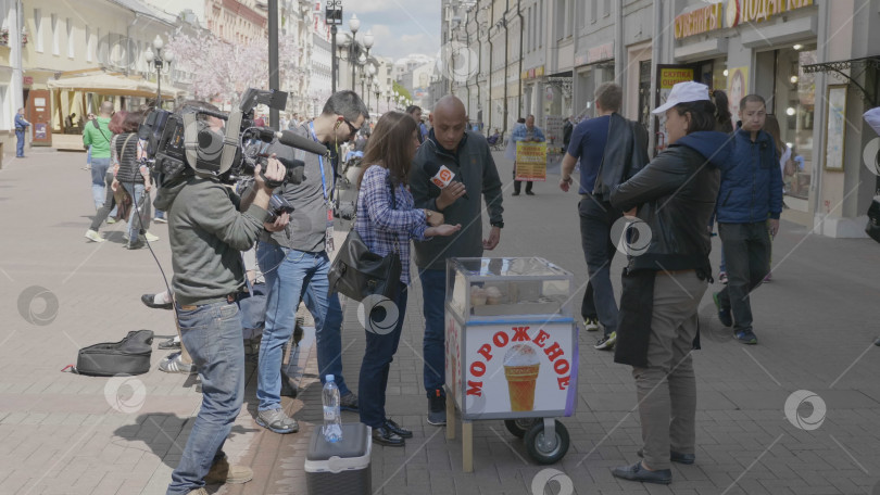 Скачать МОСКВА - 7 июня: Съемочная группа берет интервью у продавца мороженого 7 июня 2017 года в Москве, Россия. фотосток Ozero