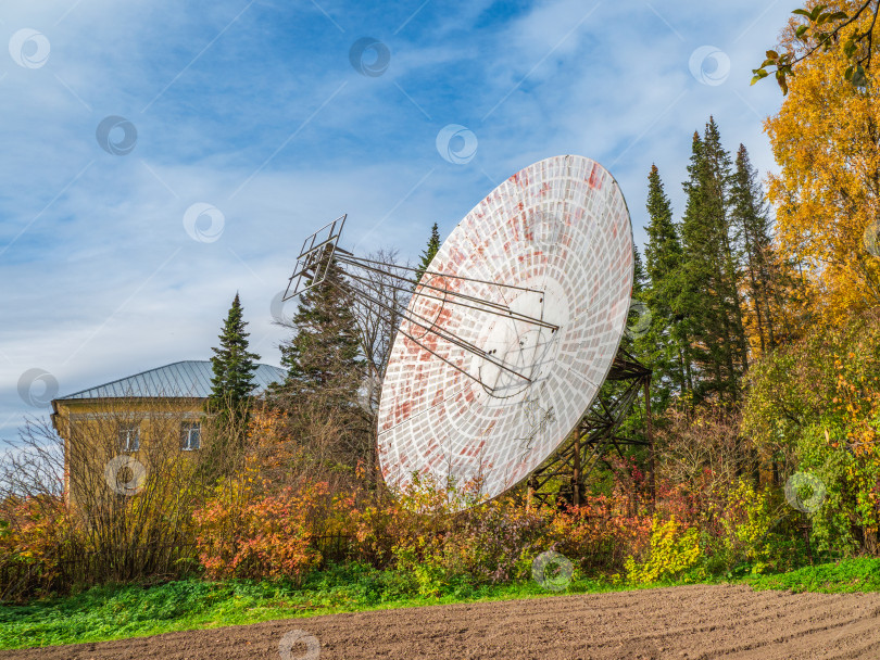 Скачать Старинный радиотелескоп, большая спутниковая антенна на фоне наблюдательного здания и голубого неба, радар в прошлом. Концепция технологии, поиск внеземной жизни, прослушивание космоса. фотосток Ozero