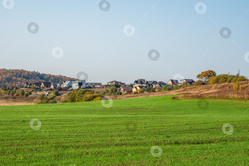 Скачать Современный коттеджный поселок в зеленом поле. Деревня в зеленой лощине. фотосток Ozero