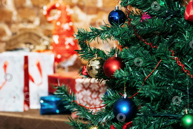 Скачать Игрушки на рождественской елке на фоне подарков фотосток Ozero