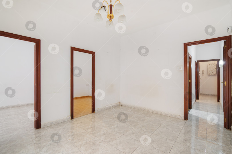 Скачать Пустой белый холл с длинным коридором и дверями, ведущими в другие комнаты. Типичная квартира в Барселоне для сдачи в аренду или продажи. фотосток Ozero